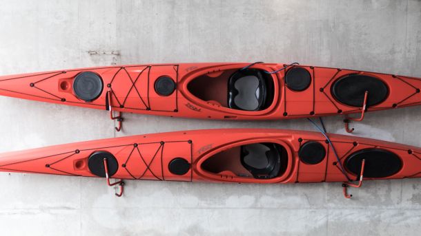 two kayaks stored on wall 6b4c3d88